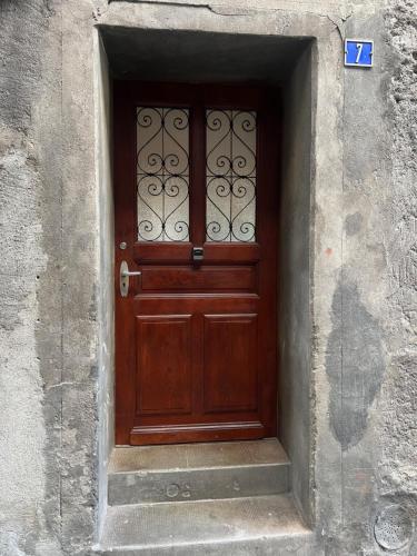 a wooden door in a stone wall with at Visp Gem for 6 in Visp