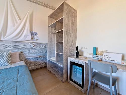 a living room with a desk and a fireplace at L'onda marina in Castelsardo
