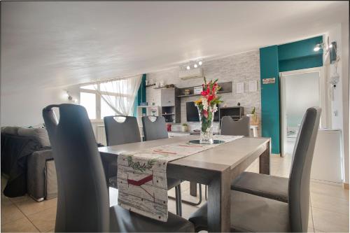 a dining room with a table and chairs at DEA SUITE APARTMENT - FIUMICINO ROME AIRPORT 5 Min - in Fiumicino