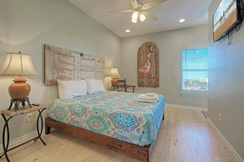 a bedroom with a bed and a ceiling fan at Laguna Village Escape 2 Home Buyout Waterfront in Padre Island