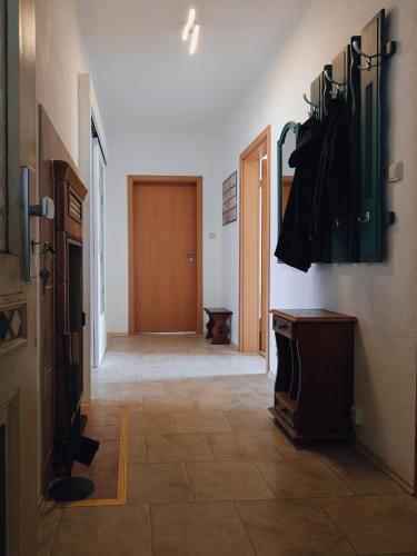 a hallway with a door and a room with a tile floor at Serenity Ferienwohnungen in Gotha in Gotha