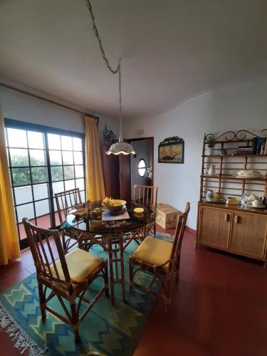 a dining room with a table and chairs at Swim&Beach Condominio Torreira in Torreira