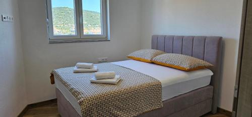1 dormitorio pequeño con 1 cama con 2 toallas en Beachfront Beauty, en Vinišće