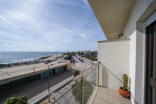 a balcony with a view of the beach at Ombak Apúlia - Sea view in Apúlia