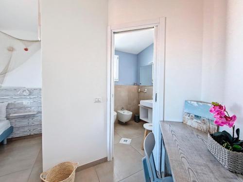 a bathroom with a sink and a toilet in a room at L'onda marina in Castelsardo