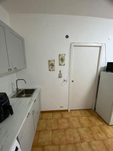 a kitchen with a sink and a refrigerator at Loft Marinella l'aereoporto di Lamezia sul mare Kitesurf in SantʼEufemia Lamezia