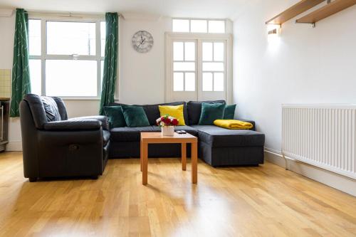 a living room with a couch and a table at Spectacular 3 Bed in Blackheath in London