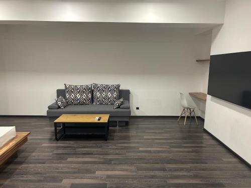a living room with a couch and a coffee table at One Day Hotel in Yerevan