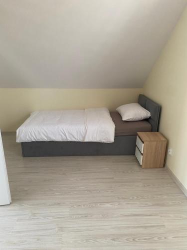 a small bedroom with a bed and a night stand at Biebrzańska Przystań 3 in Goniadz
