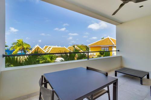a balcony with a table and a view at SENSES Boutique Hotel & Apartments in Kralendijk