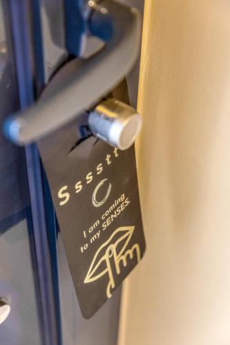 a close up of a door with a tag on it at SENSES Boutique Hotel & Apartments in Kralendijk