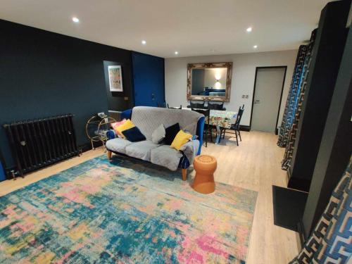 a living room with a couch and a rug at Harmony Cottage in Eglinton