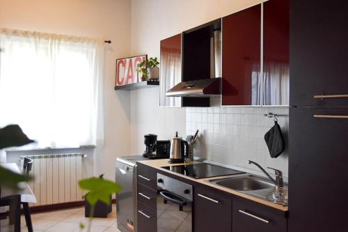 a kitchen with a sink and a counter top at CA' GIALLA 5 - sul Lago di Lugano, Dog friendly, Balcone & Parcheggio - in Cadegliano Viconago