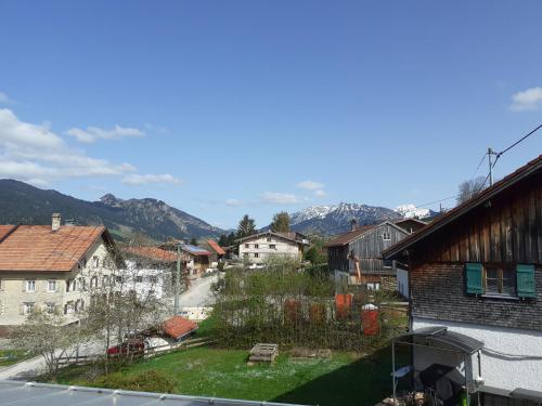 a view of a town with mountains in the background at Berggasthof Sonne Allgäu in Sonthofen