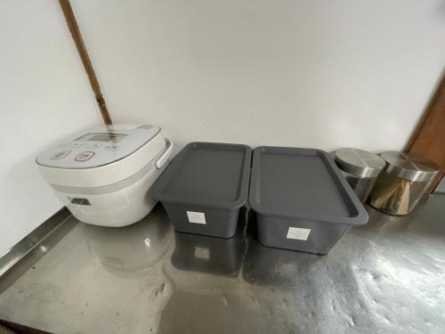 a bathroom with a toilet and three trash cans at BLUE HOUSE - Traditional Home - 5min, Beach, Bus, Train in Beppu