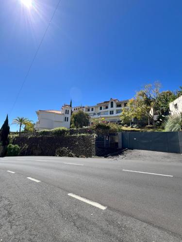 an empty road in front of a large house at Sun Hills Panoramic Views in Funchal