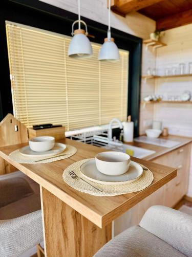 a kitchen with two bowls on a wooden table at BeLaWood in Egerszalók