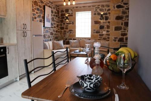 a kitchen with a wooden table with a bowl of fruit on it at Studio Sofia in Balíon