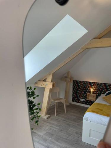a attic room with a bed and a desk at Thuit de l'Oison - Superbe appartement F2 duplex in Le Thuit-Simer