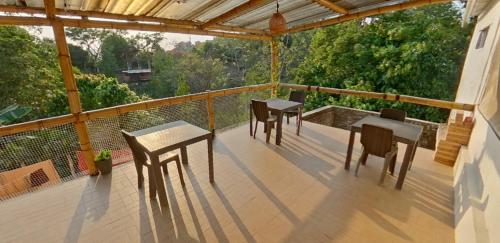 a balcony with two tables and two chairs on it at Akainoie in Minca