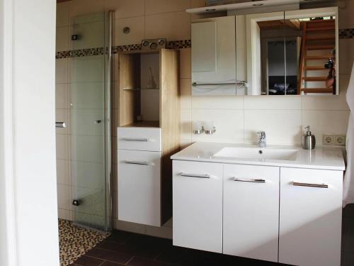 a white bathroom with a sink and a shower at Cottage, Kaltennordheim in Kaltennordheim