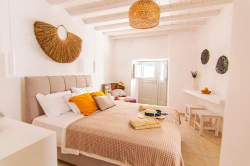 1 dormitorio con 1 cama con almohadas de color naranja y blanco en windmills suite by opus en Mykonos