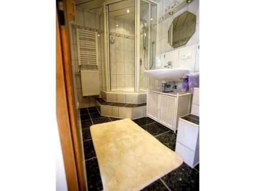 a bathroom with a sink and a shower and a mirror at Ziegler 2 Modern retreat in Berchtesgaden