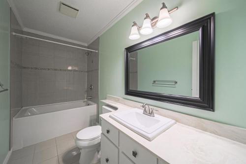 a bathroom with a sink and a toilet and a mirror at The beautiful house welcomes you in Delta