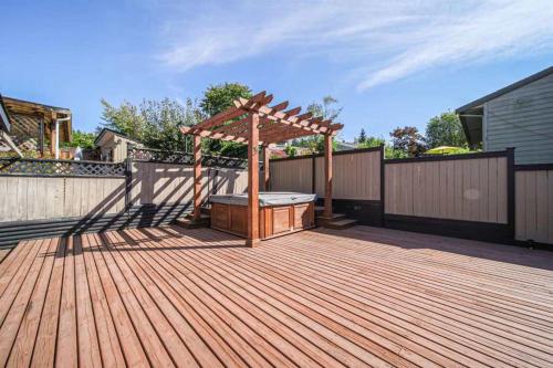 a wooden deck with a gazebo and a hot tub at The beautiful house welcomes you in Delta