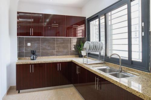 a kitchen with a sink and a large window at Residence Mandela Almadies Dakar, Senegal, Ngor Almadies in Ngor