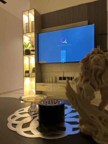 a living room with a table with a lion statue and a tv at شقه فاخره in Riyadh