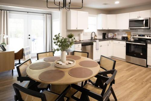 a kitchen with a wooden table with chairs and a dining room at Refreshing Ranch Style Home in McDonough