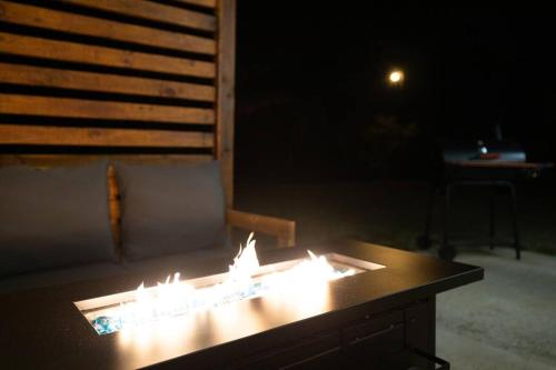 a table with lit candles on top of it at night at Refreshing Ranch Style Home in McDonough