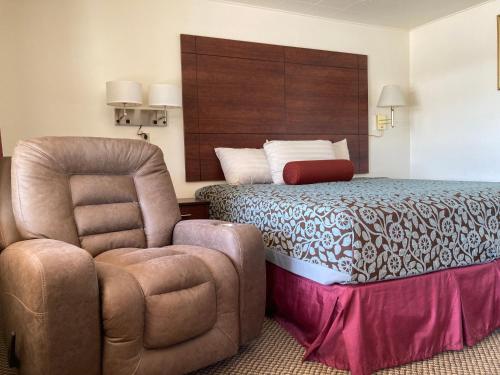una camera d'albergo con letto e sedia di Hills Inn a Hot Springs