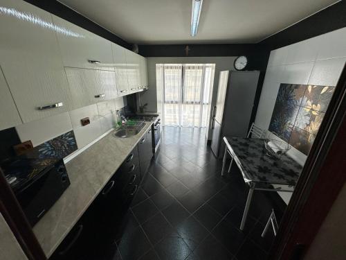 a kitchen with a counter and a table in it at Nicoreb apartament in Brăila