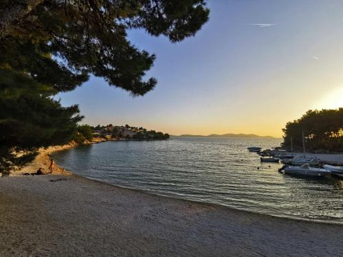a view of a lake with boats on the shore at Mobile homes Laguna, beach Porat, Drage in Drage