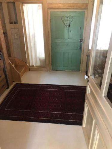 a room with a door with a rug in front of it at French Farmhouse between Lake & Mountain in Héry-sur-Alby