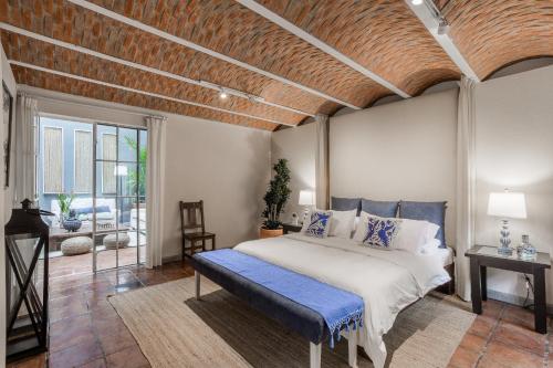 a bedroom with a large bed with a wooden ceiling at Casa Tranquilo, 4BR Home by Rosewood with Hot Tub in San Miguel de Allende