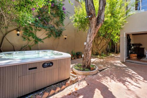 a hot tub next to a tree in a yard at Casa Tranquilo, 4BR Home by Rosewood with Hot Tub in San Miguel de Allende