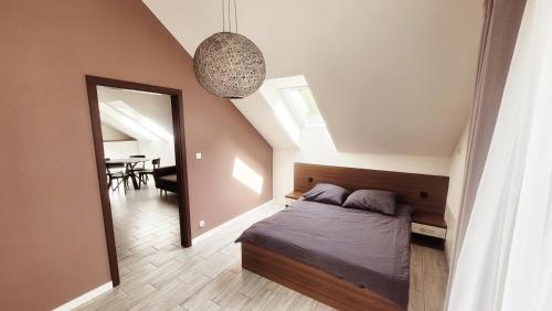 a bedroom with a bed and a mirror and a table at apartamenty nad jeziorem in Turawa