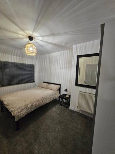 a bedroom with a bed and a television in it at Quiet family home in Tettenhall