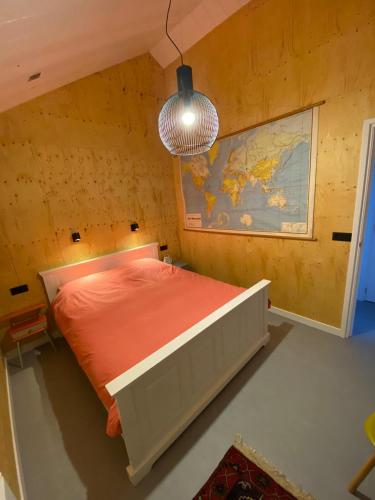 a bedroom with a bed and a map on the wall at De Woudvaart Sneek in Sneek