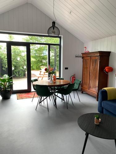 a living room with a table and chairs at De Woudvaart Sneek in Sneek
