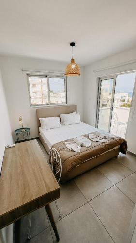 a bedroom with a large bed and a table at WAKE UP BY THE SEA FLATS in Protaras