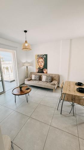 a living room with a couch and a table at WAKE UP BY THE SEA FLATS in Protaras