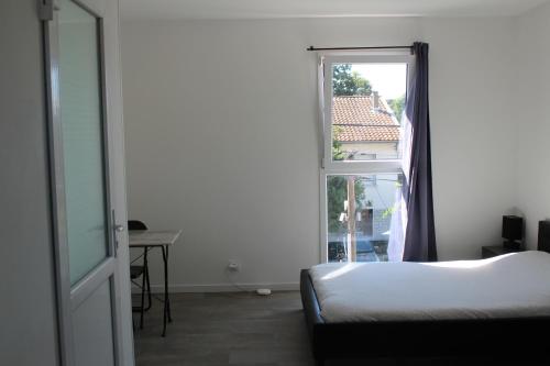 a bedroom with a bed and an open window at Etablissements Coulon - Talence (Chemin d'Ars) in Talence