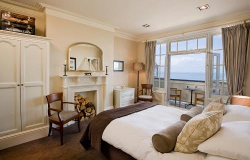 a bedroom with a large bed and a fireplace at The Marine in Whitstable
