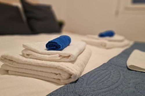 a group of towels sitting on top of a bed at Blue pearl, seaside aprtm with pool at Latchi Marina in Polis Chrysochous
