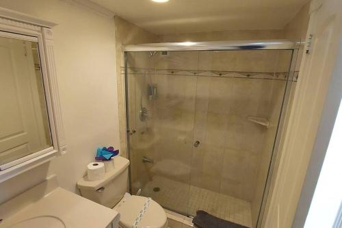 a bathroom with a toilet and a glass shower at Komffy Home with King Bed & Ocean View at Tides in Hollywood