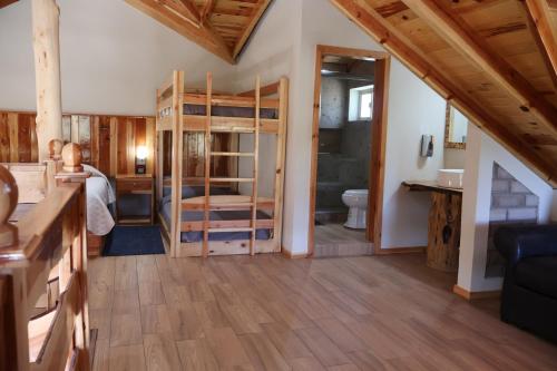a large room with a bathroom and a bedroom at Grand Mountain Cabañas Creel in Creel
